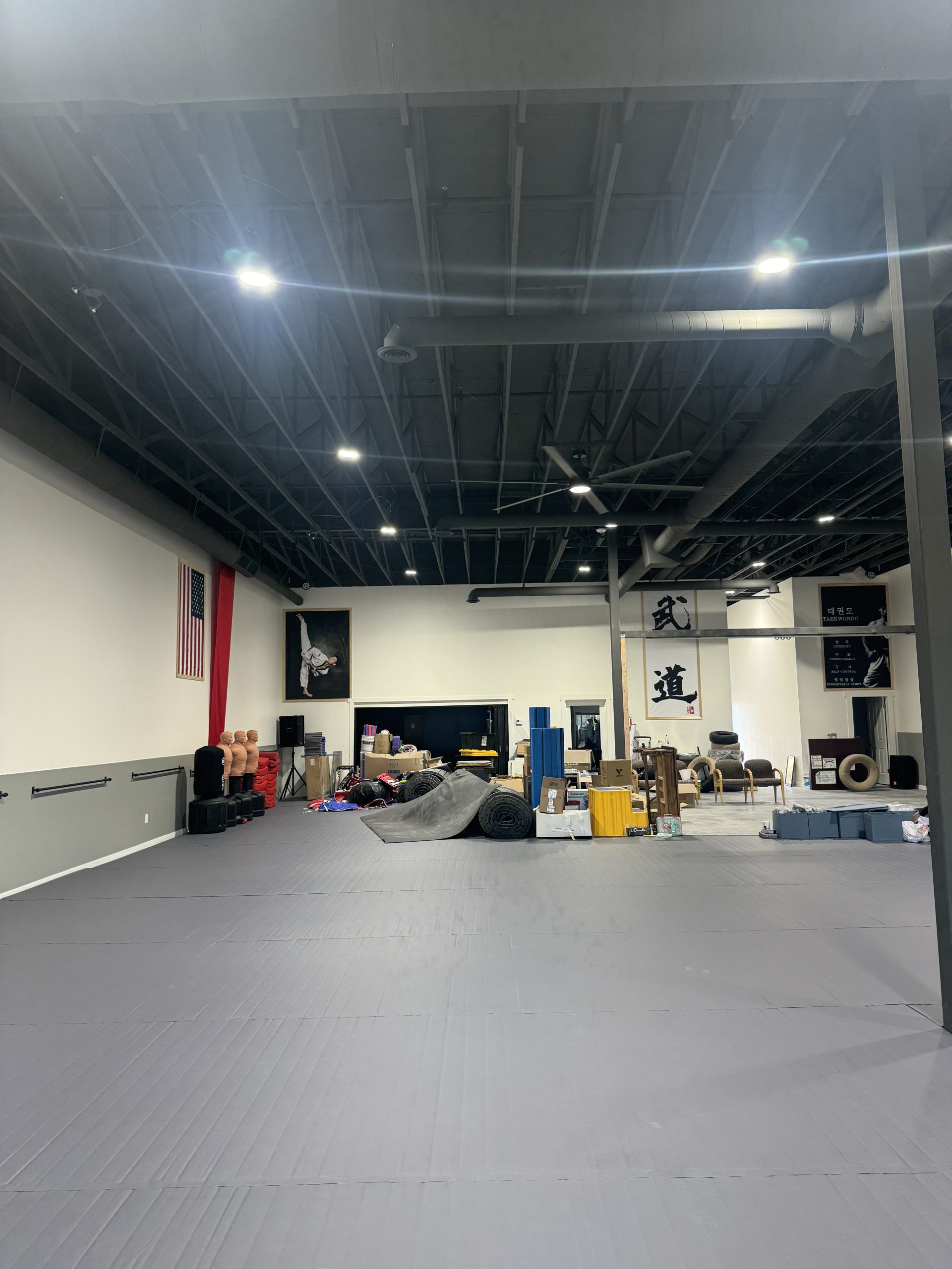 Martial arts gym with black painted ceiling and gray walls