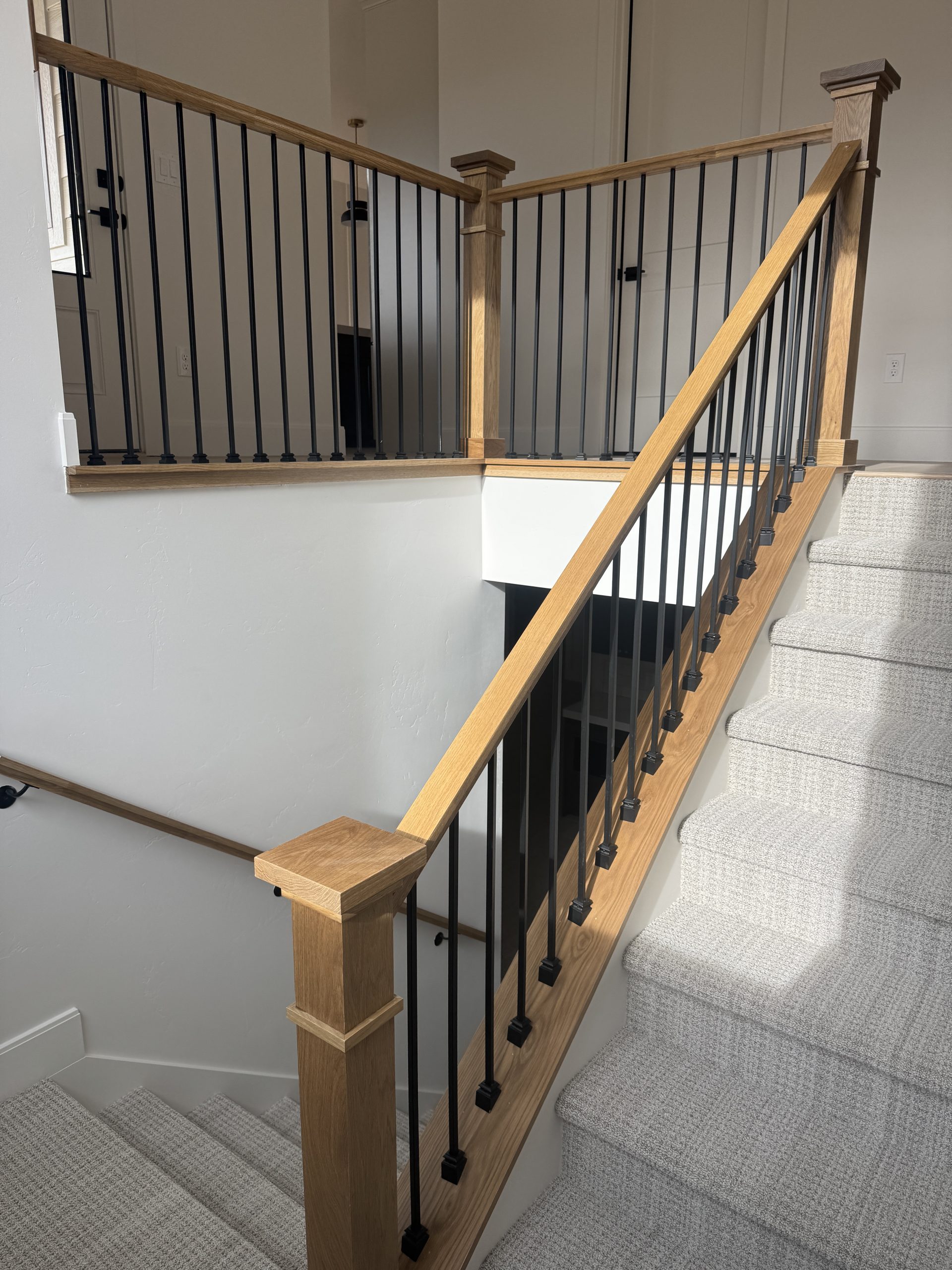 Oak stair railing with painted risers and trim